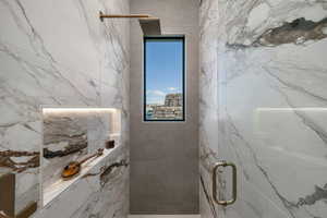 Full bathroom featuring a marble finish shower