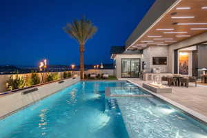 Integrated pool / hot tub featuring area for grilling, a fenced backyard, and a patio area