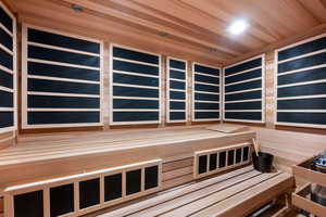 Relaxing sauna featuring wood ceiling and recessed lighting