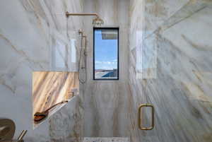 Full bathroom featuring a marble finish shower
