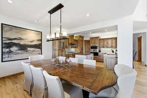 Dining area featuring light wood-style flooring and hanging lights