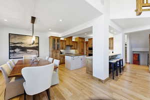 Dining area with light wood-style flooring and recessed lighting