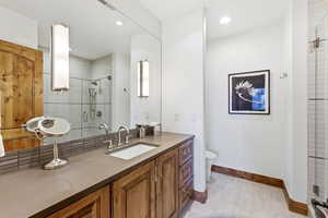 Bathroom with vanity and tiled shower