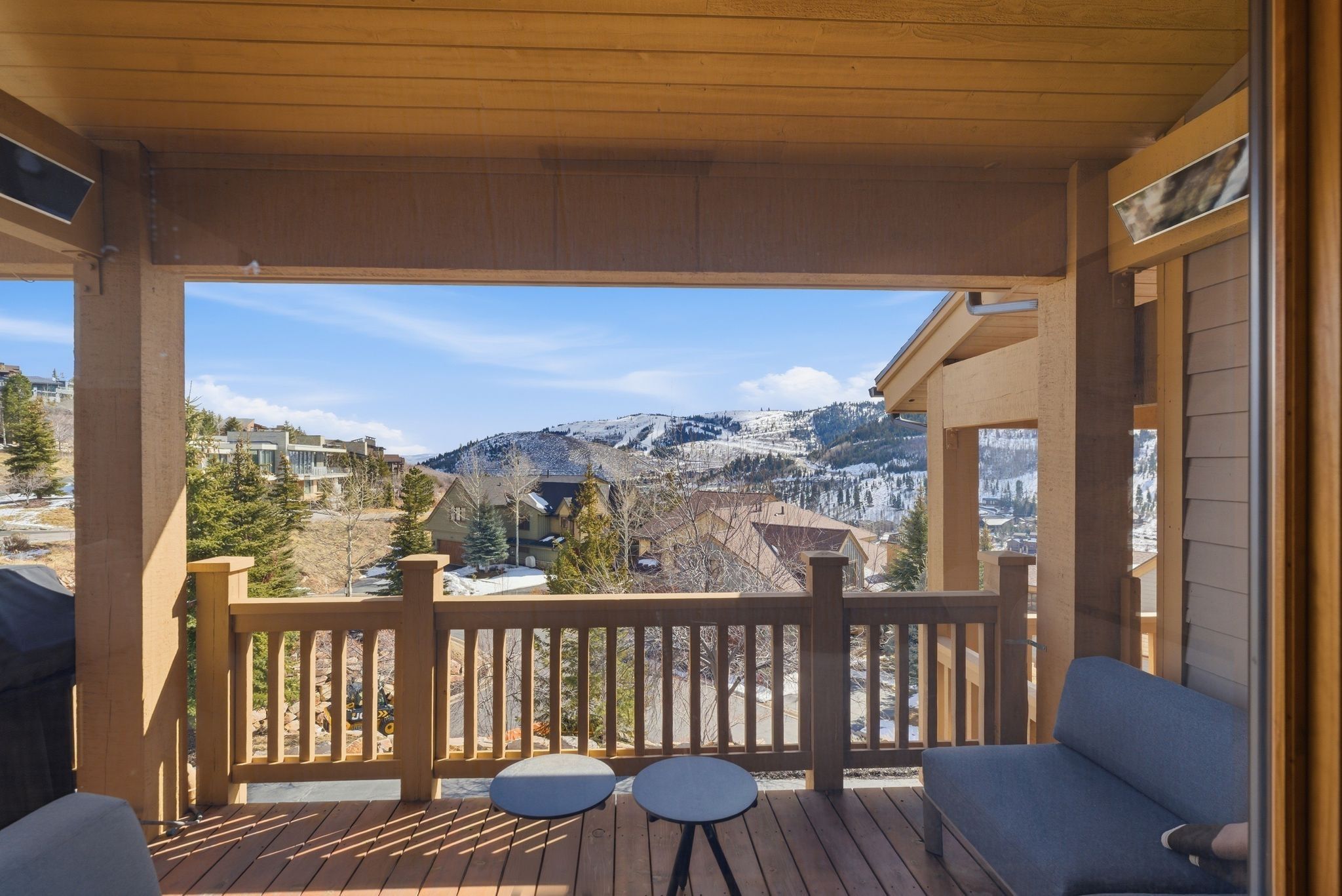 Covered outdoor deck with wood-finish flooring and railing