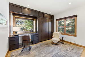 Home office featuring light wood-style flooring and recessed lighting