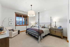 Bedroom with light colored carpet and recessed lighting