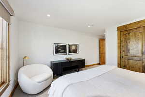 Carpeted bedroom with baseboards and recessed lighting