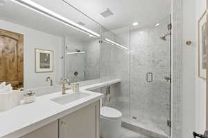 Full bath featuring vanity and a shower stall