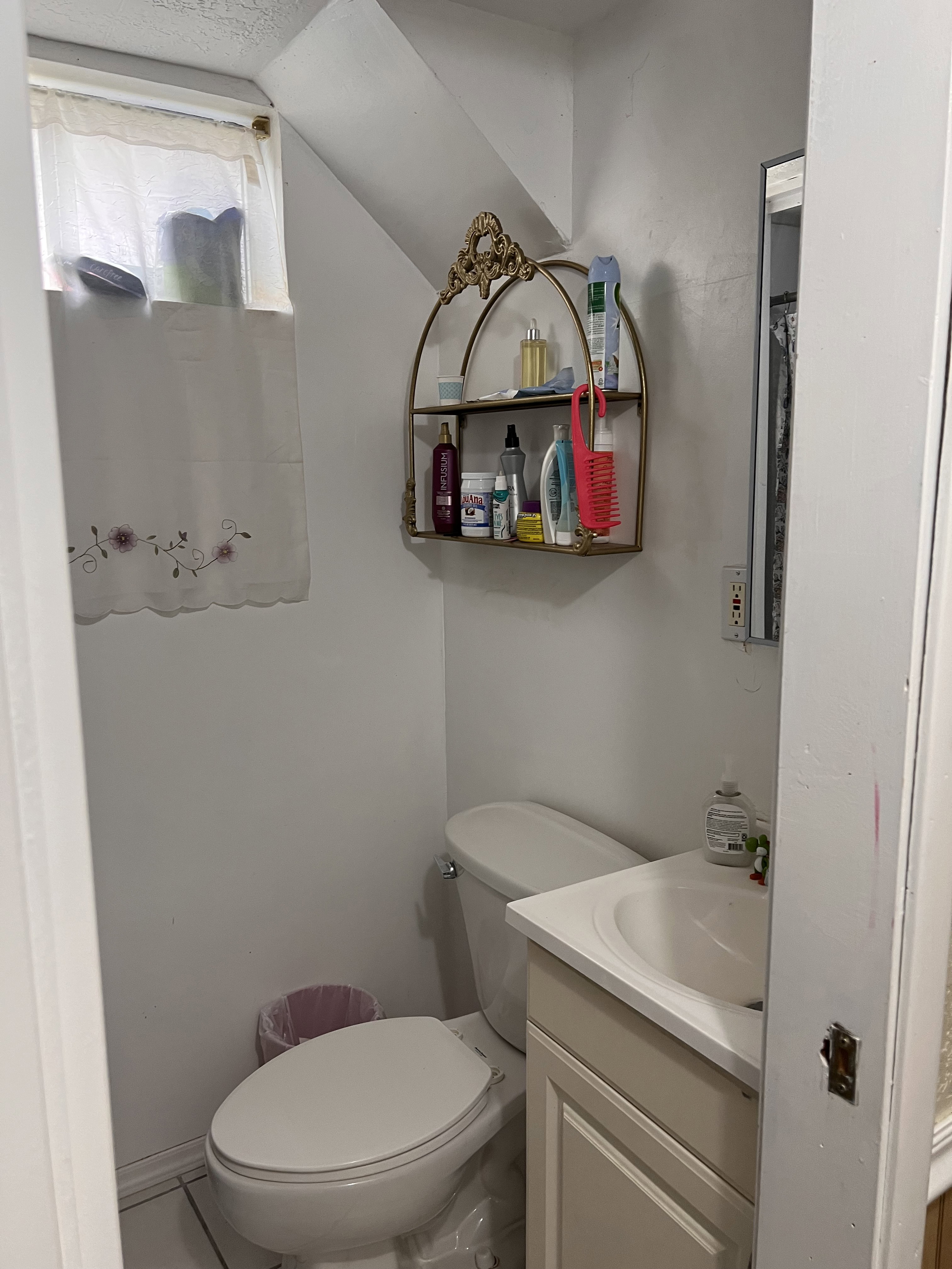 Bathroom featuring vanity and lofted ceiling