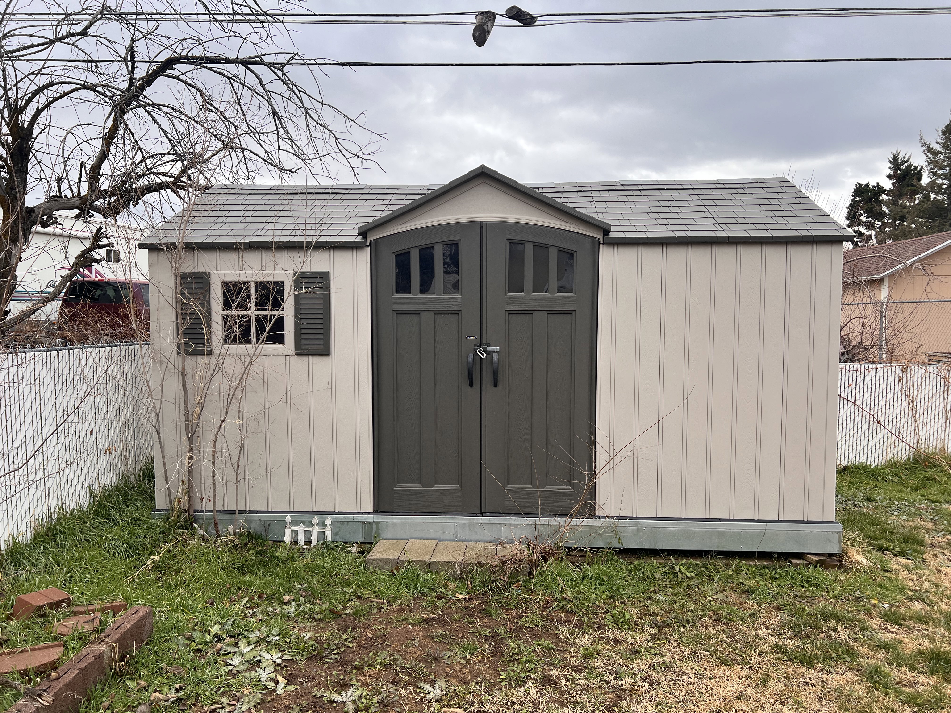 View of shed with a fenced backyard