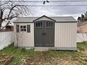 View of shed with a fenced backyard