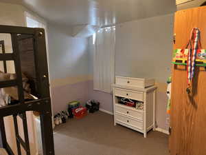 Carpeted bedroom featuring baseboards