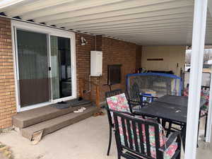 View of patio featuring outdoor dining space and entry steps