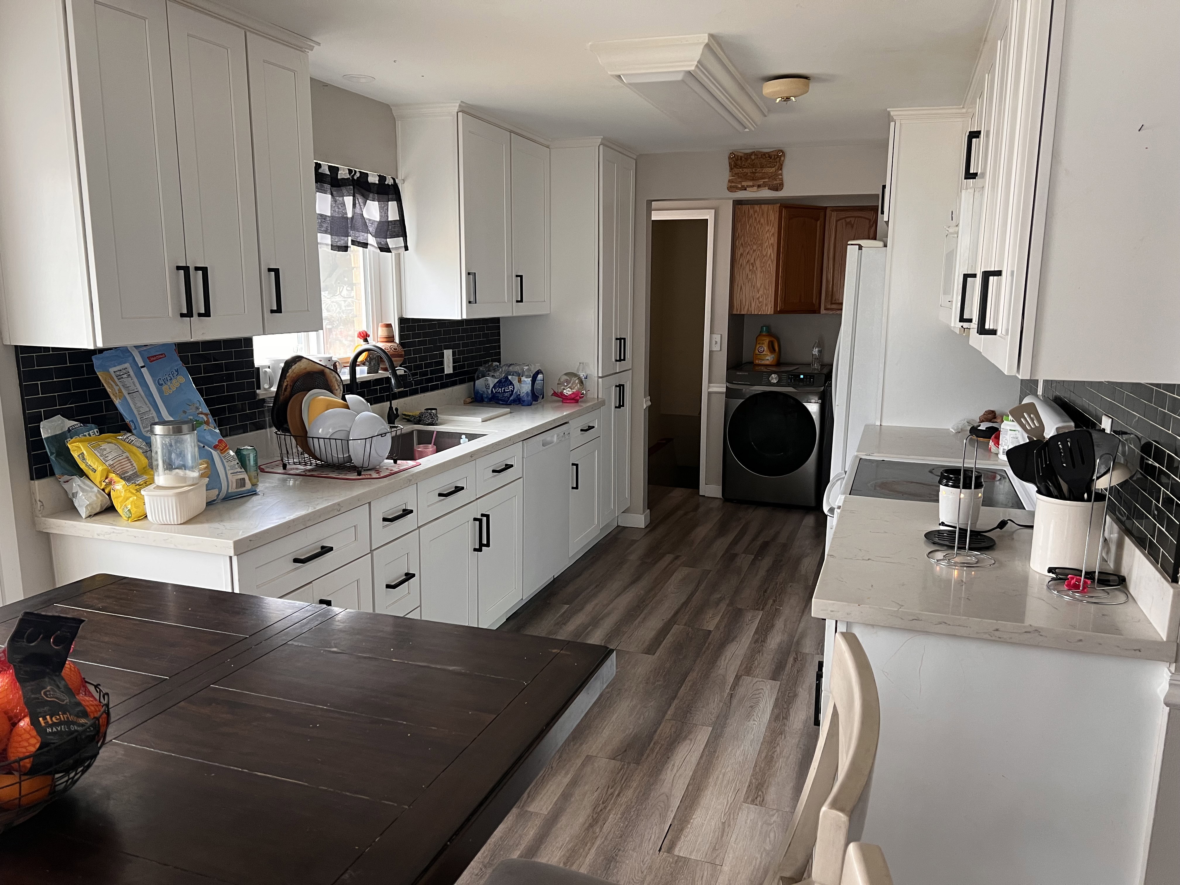Kitchen with decorative backsplash and white cabinetry