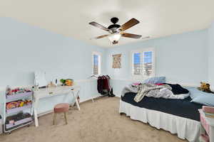 Bedroom with carpet floors and a ceiling fan