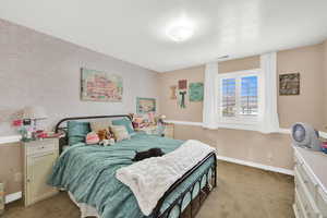 Bedroom featuring light carpet