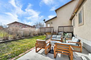 View of patio with outdoor seating and a wooden deck
