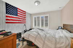 Bedroom featuring wooden walls