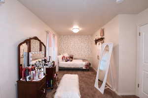 Carpeted bedroom featuring baseboards