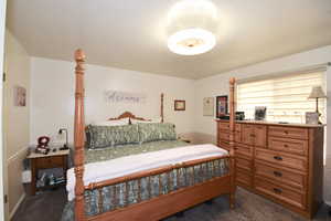 Bedroom featuring dark carpet