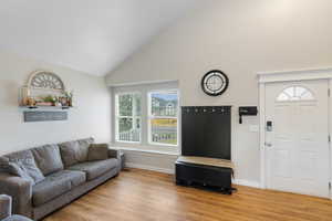 Living area featuring light wood finished floors and lofted ceiling