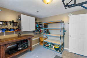 Garage featuring baseboards and a workshop area
