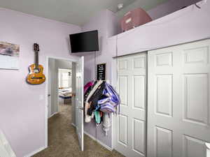 Corridor with carpet flooring and baseboards