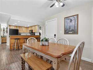 Dining space featuring dark wood-type flooring, ceiling fan, and recessed lighting