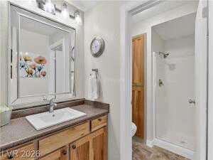 Bathroom featuring vanity and a shower stall