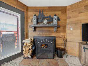 Detailed view of wooden walls and a warm lit fireplace