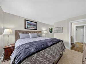 Bedroom featuring light colored carpet