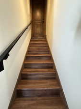 Stairs featuring wood finished floors