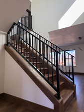 Stairs featuring wood finished floors