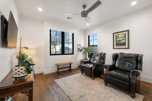 Sitting room with dark wood finished floors, a ceiling fan, and recessed lighting