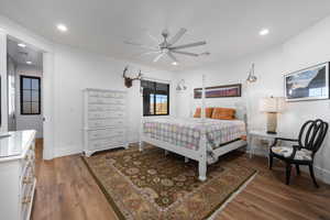 Bedroom with dark wood-style flooring, ceiling fan, and recessed lighting
