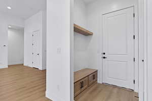 Mudroom featuring light wood-type flooring and recessed lighting