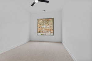 Unfurnished room featuring light carpet and ceiling fan