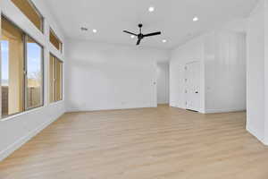 Empty room featuring ceiling fan, light wood finished floors, and recessed lighting