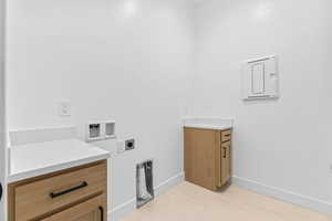 Laundry area featuring washer hookup, cabinet space, and hookup for an electric dryer