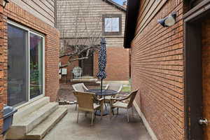 View of patio / terrace featuring outdoor dining area and entry steps