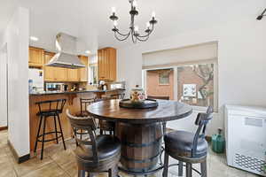 Dining space with hanging lights, heating unit, and light tile patterned floors