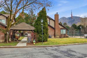 View of front of property with a chimney and a mountain view