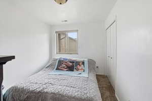 Bedroom featuring carpet flooring and a closet