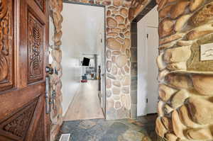 Hall featuring stone flooring