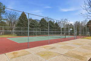 View of tennis court with community basketball court