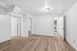 Spare room featuring light wood-type flooring and washer / dryer