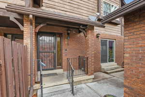 Doorway to property with brick siding