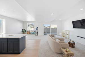 Living area featuring recessed lighting and light carpet