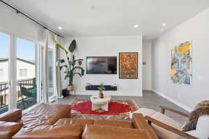Living area with recessed lighting and wood finished floors