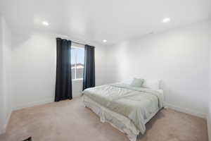 Bedroom with light carpet and recessed lighting